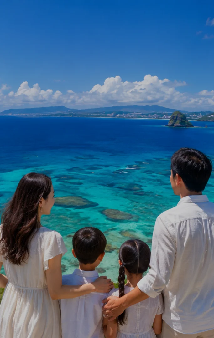 A family of four stands together looking out over the expansive blue ocean in Okinawa.