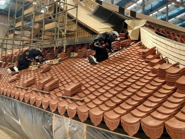 On 31 October 2024, it will be five years since the fire that tragically destroyed Shuri Castle. Today, carpenters are working tirelessly to restore this iconic UNESCO World Heritage Site, using traditional techniques to bring it back to its former glory 🏯✨

The primary restoration work is being carried out by Miyadaiku (宮大工)🔨, a specialized group of carpenters responsible for constructing and repairing wooden structures such as shrines, temples, and important cultural properties. They masterfully recreate ancient techniques, including intricate wood joinery, all by hand.

One of the most iconic features of Shuri Castle is its striking red exterior, created by its red roof tiles and vermilion lacquer. Initially, there were concerns about shortages of both the raw materials and skilled craftsmen needed to produce these tiles. However, the restoration work is progressing steadily 🛠️

The theme of the restoration is "visible restoration," allowing visitors a rare opportunity to witness Japan’s ancient architectural skills in action. Visitors can also view a variety of exhibits showcasing remaining objects and materials related to the fire and the ongoing restoration efforts, providing a deeper understanding of the castle’s history and the monumental task of restoring it.

This once-in-a-lifetime experience will only be available until the expected completion in 2026. While visiting the fully restored castle will also be a special occasion, don’t miss your chance to see history being revived before your eyes!⭐

Photo courtesy of: Okinawa Commemorative National Government Park Office

#Okinawa #Okinawaprefecture #Visitokinawa #Exploreokinawa #Shuricastle #Castlerestoration #Okinawacastle #Okinawaculture #Okinawaheritage #UNESCO