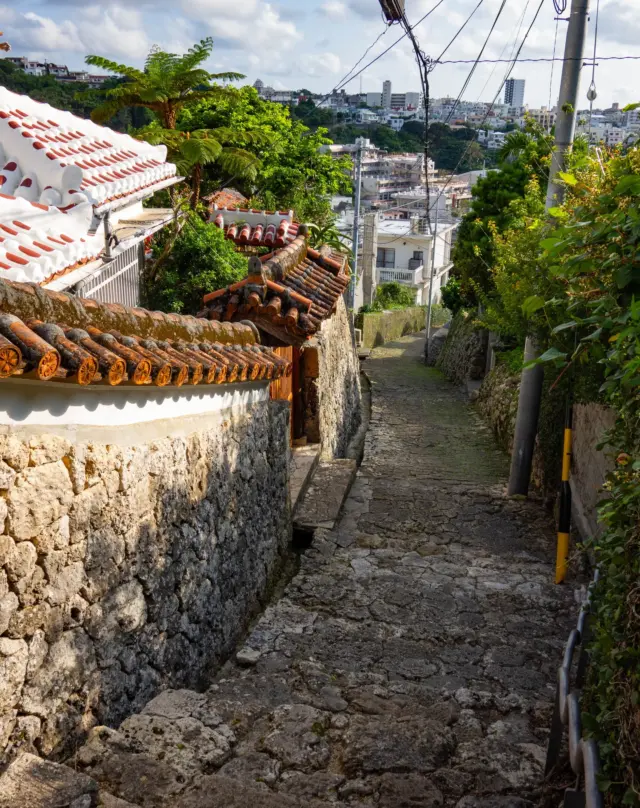 Follow a quiet stone path in Okinawa and you may find yourself walking through centuries of history🏝️✨

The Shuri Kinjo-cho Stone-paved Road is believed to be part of the historic Madama-Michi Path that once connected Shuri Castle and Naha Port. Since the days of the Ryukyu Kingdom, people have walked this gentle slope.

Lined with red-tiled roofs and stone walls🧱, the path still preserves glimpses of everyday Okinawan life. More than a sightseeing spot, it feels like walking through layers of history ⏳

💬 What road from your travels made you feel connected to the past?

📸 Photo by @bunryu_10ma
Have your own Okinawa memories to share?
Tag your post with both #visitokinawajapan and #beokinawa for a chance to be featured next!

#Okinawa #Okinawaprefecture #Visitokinawa #Exploreokinawa #Discoverokinawa #Okinawasggo #Tradition #Culture #Okinawatradition #Okinawaculture #History #Okinawahistory #Historicalroad #Historicalsightseeing #Historylovers #Culturelovers #Indepthokinawa #Historytravel #Culturaltravel #Slowtravel #Okinawaexploration #Hiddenjapan #Hiddenokinawa #Shuri #Ryukyu